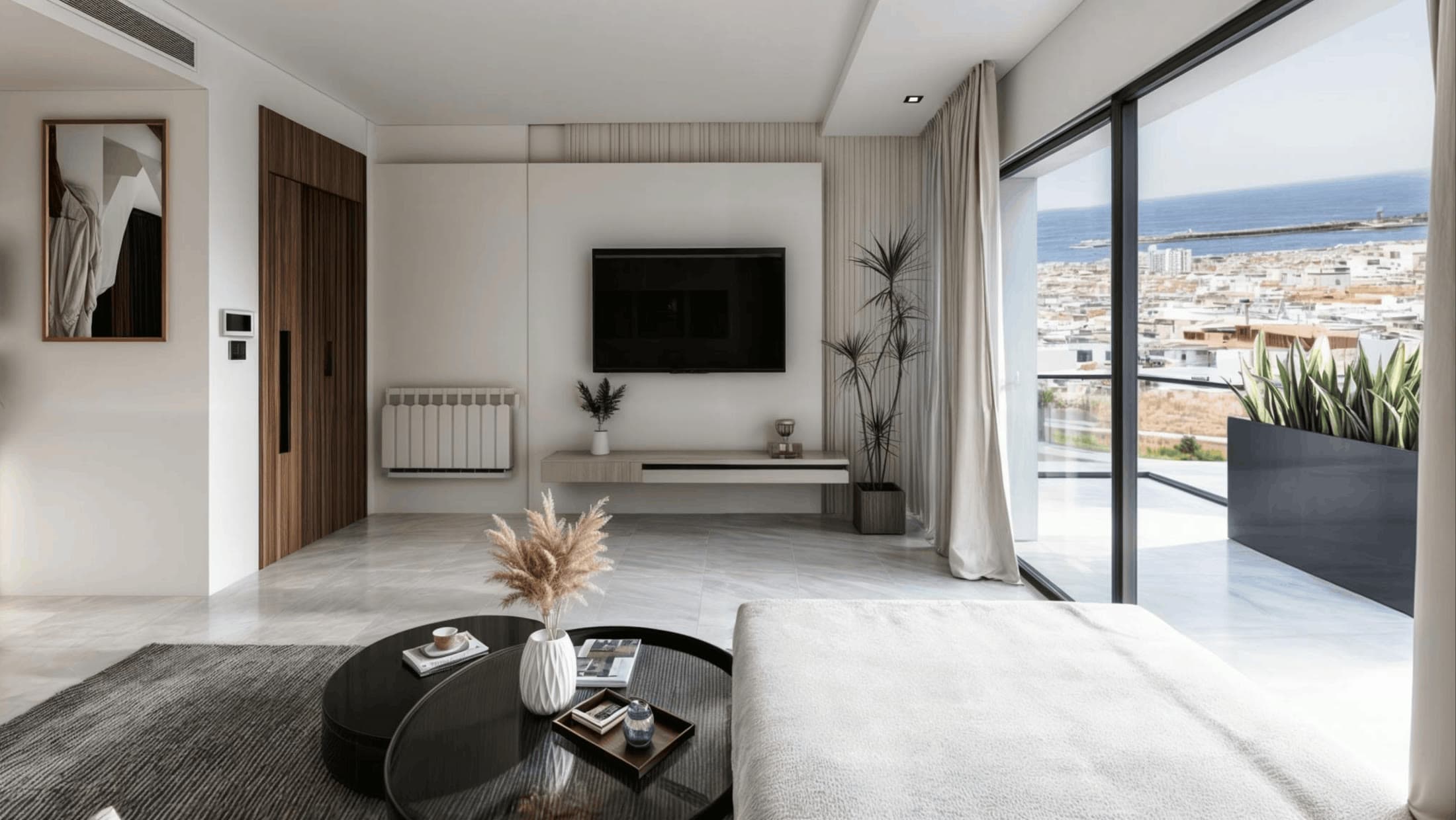 Salon d’Élite vers la terrasse : baie vitrée toute hauteur en aluminium noir et panorama depuis le sixième étage.