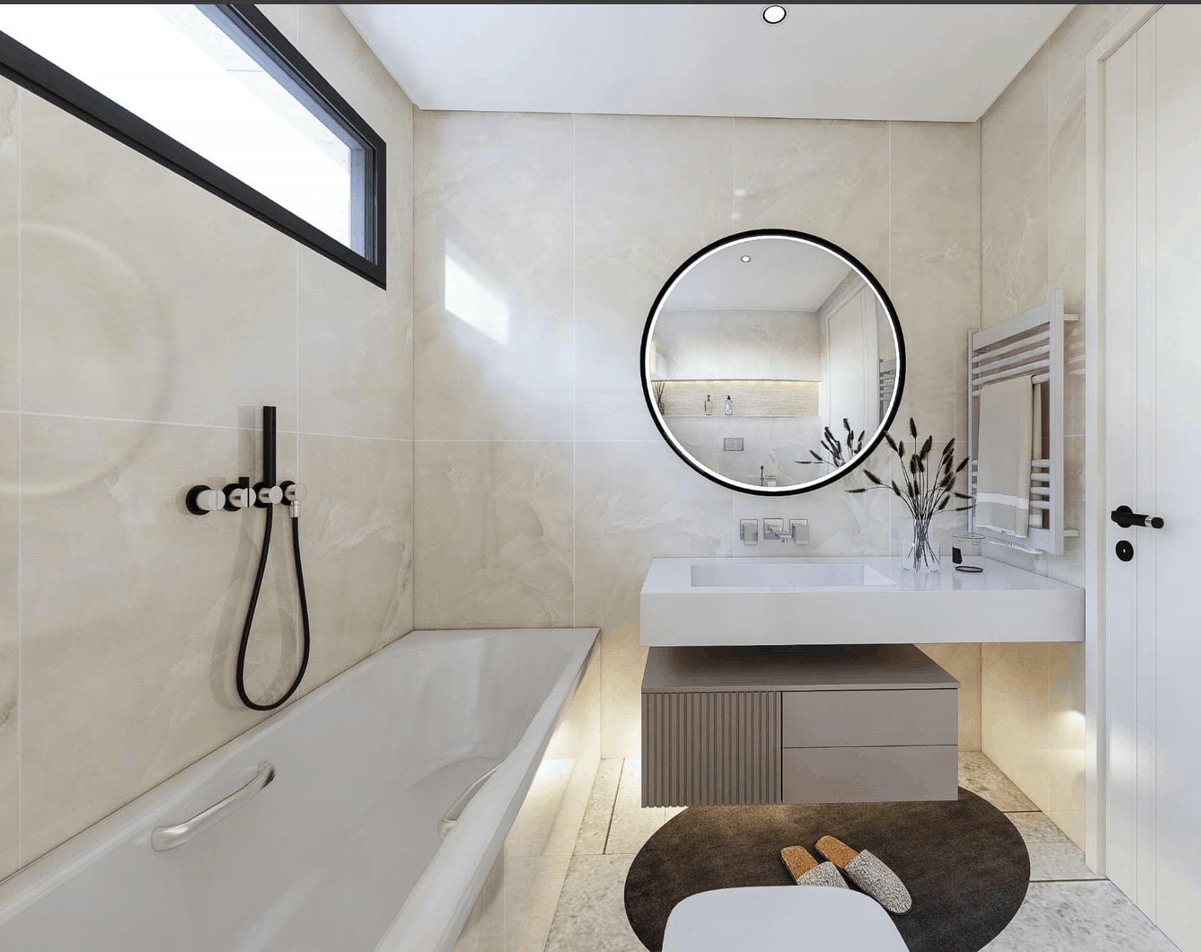 Salle de bains de L’Arcane : plan vasque, miroir rond et sèche-serviette.